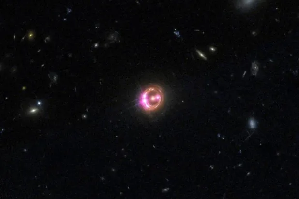 Multiple images of a distant quasar are visible in this undated combined view from NASA’s Chandra X-ray Observatory and the Hubble Space Telescope. (Reuters/NASA handout via Reuters)