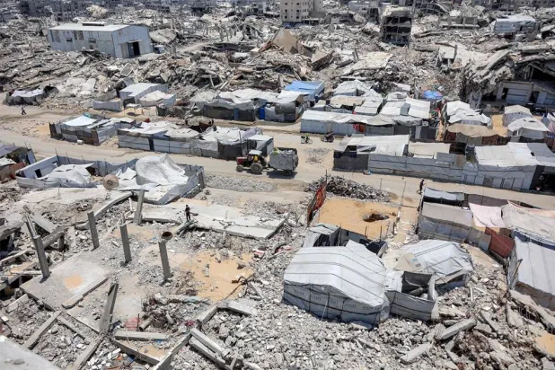 Tents and shelters are pictured next to rubble of collapsed buildings at a camp for people displaced by war in the Sheikh Radwan neighborhood of Gaza City on July 6, 2026. (AFP)