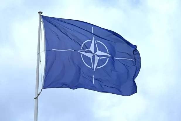 FILED - 19 May 2026, Belgium, Brussels: FILE PHOTO - A flag with the NATO logo flies in the wind in front of the NATO headquarters in Brussels. Photo: Elisa Schu/dpa