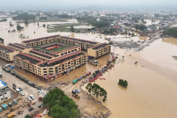 A drone view shows rescue workers conducting relief operations in flood-affected Maling town, after the Liulan reservoir dam breach, following heavy rainfall brought by typhoon Maysak, in Hengzhou, Guangxi Zhuang Autonomous Region, China, July 8, 2026. China Daily via REUTERS 