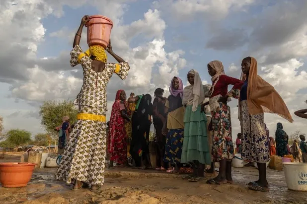 FILE -Women and children fetch water at dusk in the Korsi Refugee Camp in Birao, the Central African Republic, March 27, 2026. (AP Photo/Caitlin Kelly, File)

