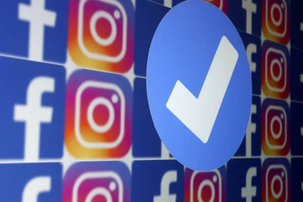 FILE PHOTO: A blue verification badge and the logos of Facebook and Instagram are seen in this picture illustration taken January 19, 2023. REUTERS/Dado Ruvic/Illustration/File Photo