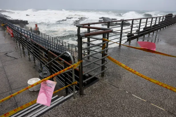 Warning tape blocks access to a coastal area as waves crash ashore while Typhoon Bavi moves close to the northern coast of Taiwan in Keelung, Taiwan, July 11, 2026. REUTERS/Ann Wang