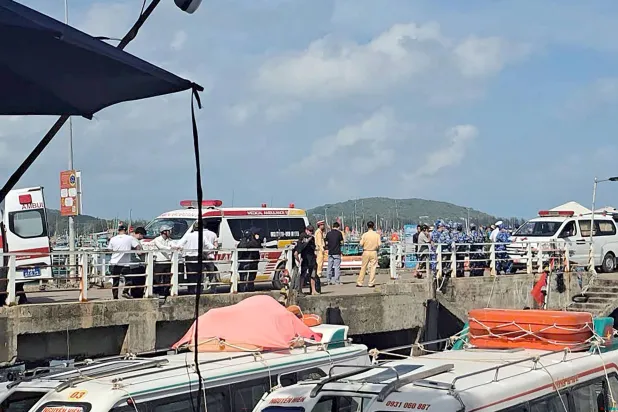 Ambulances line up on a pier to help victims of a boating accident after a tourist vessel capsized off Phu Quoc Island in southern Vietnam's An Giang Province on July 11, 2026. (Photo by AFP)
