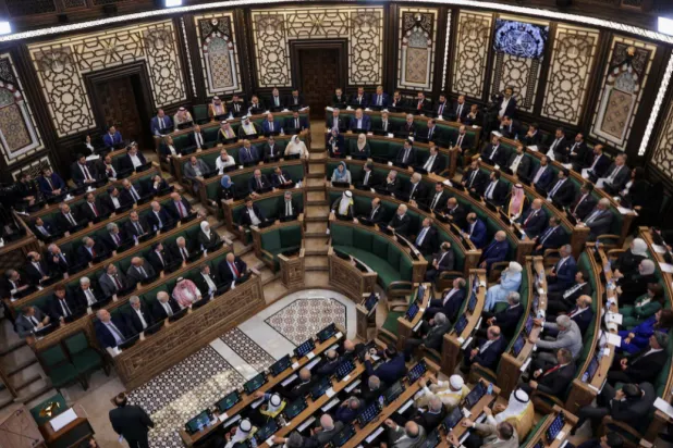  Members of Syria's newly formed People's Assembly attend the body's inaugural session, the first parliament session since the end of the rule of ousted Syrian President Bashar al-Assad, in Damascus, Syria, July 12, 2026. REUTERS/Khalil Ashawi 