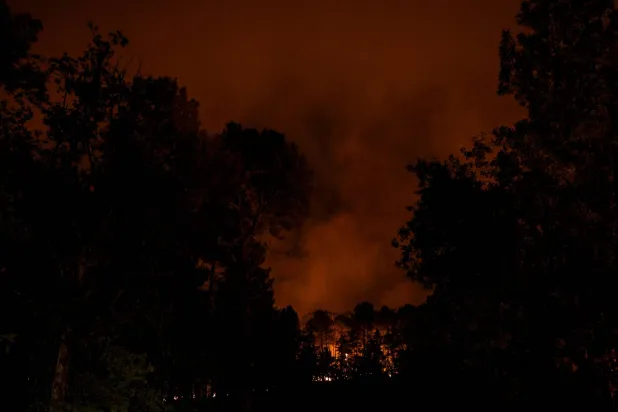 Flames rise in the Fontainebleau Forest after a forestfire broke out late afternoon on July 12, 2026. (Photo by GEOFFROY VAN DER HASSELT / AFP)