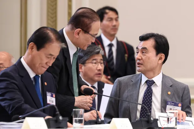 South Korean Defense Minister Ahn Gyu-back (R) talks with National Security Adviser Wi Sung-lac (C) during the National Fiscal Strategy Meeting, chaired by South Korean President Lee Jae Myung, at the presidential office Cheong Wa Dae in Seoul, South Korea, 13 July 2026.  EPA/YONHAP