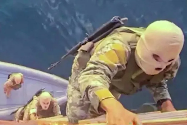 This screen grab taken from undated video footage released by Iran's Revolutionary Guards (IRGC) and made available via Iran's state broadcaster (IRIB) on April 23, 2026, shows IRGC naval forces allegedly boarding a ship attempting to cross the Strait of Hormuz. (Photo by IRIB TV / AFP) /