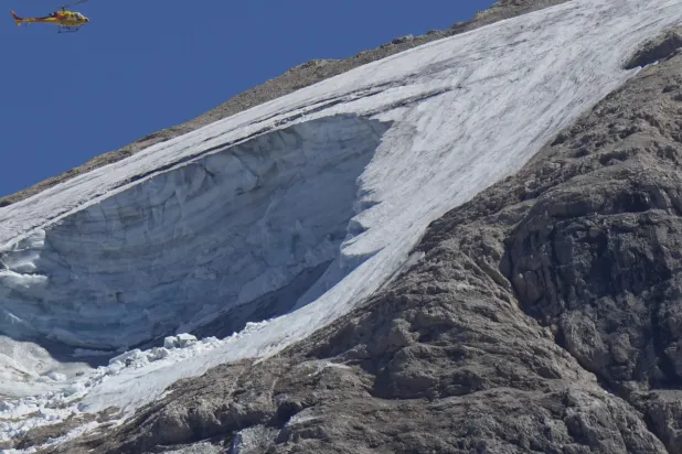 A rescue helicopter hovers over the Punta Rocca glacier near Canazei, in the Italian Alps in northern Italy, July 4, 2022 - File photo/AP news