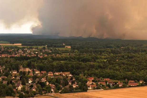  A drone view from Milly-la-Foret shows smoke rising from a wildfire in the Fontainebleau forest near Paris during a heatwave affecting large parts of France, July 13, 2026. (Reuters)