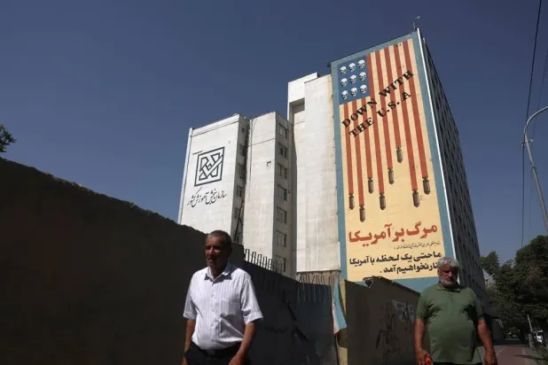 People walk near an anti-US mural in Tehran, Iran, July 13, 2026. Majid Asgaripour/WANA (West Asia News Agency) via Reuters