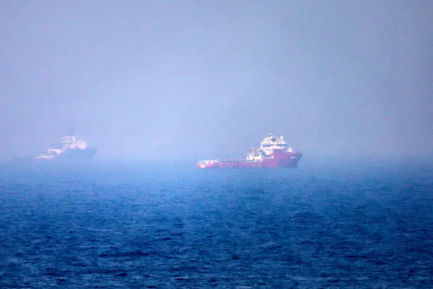 TOPSHOT - This picture shows ships sailing near the Strait of Hormuz off the eastern coast of the United Arab Emirates at Khor Fakkan on July 13, 2026. (Photo by AFP) / 