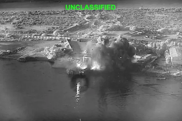  This image from video released by US Central Command, shows an explosion at Bandar Abbas Naval Base, Iran, as three Corsair unmanned surface vessels, also called one-way attack surface drones, fired by the US military, hit the port July 12, 2026. (US Central Command via AP) 