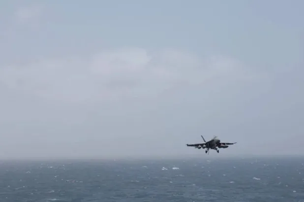 An aircraft prepares to land aboard the USS George H.W. Bush, at an unknown location, released July 14, 2026, in this still image taken from a handout video. US Central Command (CENTCOM)/Handout via Reuters