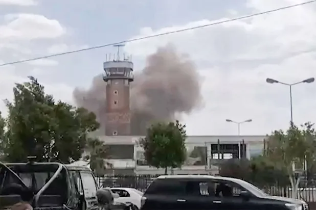 Graphic content / TOPSHOT - This screen grab taken from a video footage made available via AFPTV on July 13, 2026 shows smoke rising from the airport in Sanaa