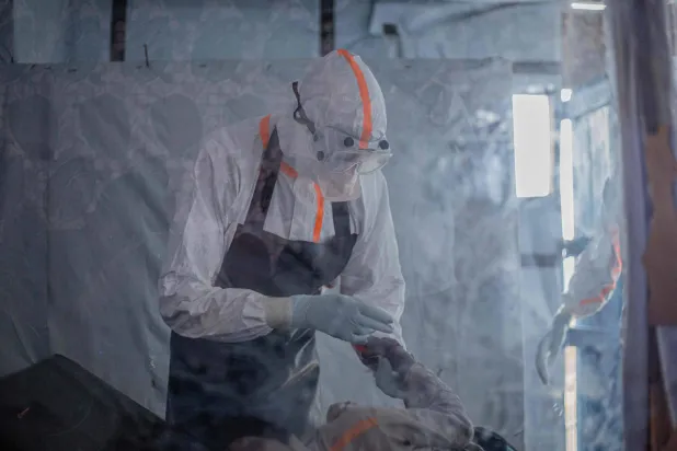A doctor provides care to a patient with Ebola virus disease at the Rwampara Ebola Treatment Centre (ETC) in Bunia, Ituri, in the east of the Democratic Republic of Congo on July 13, 2026. (Photo by BENEDICTION MURHABAZI / AFP)