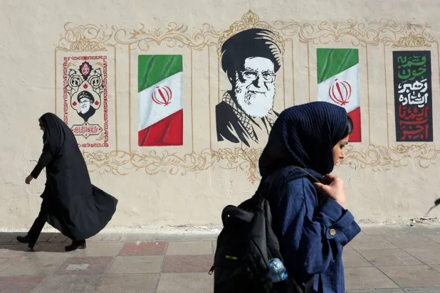 Iranian women walk past a mural of late Iranian Supreme Leader Ali Khamenei on a street in Tehran, Iran, 15 July 2026. (EPA) 
