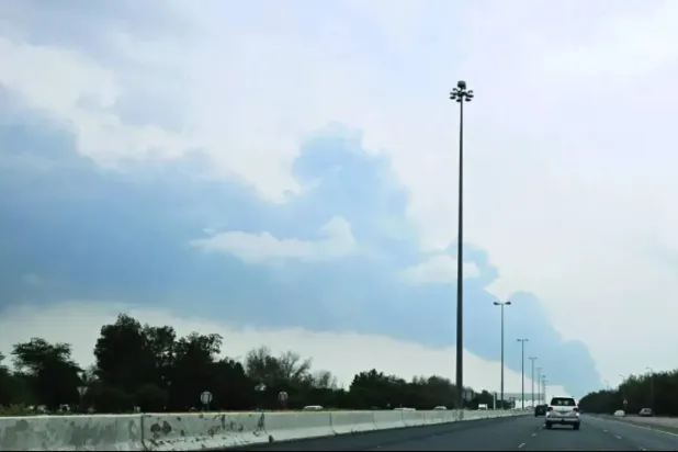 Smoke rises near Kuwait International Airport after a drone strike targeted a fuel depot. (File photo/AFP)