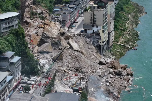  In this photo released by Xinhua News Agency, rescuers conduct search and rescue operation on the site of the landslide in Pengshui County in southwestern China's Chongqing on Friday, July 17, 2026. (Xinhua via AP) 