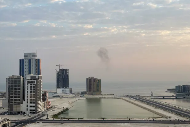 Smoke rises after a drone was intercepted during early morning hours in Manama, Bahrain, July 14, 2026. REUTERS/Stringer
