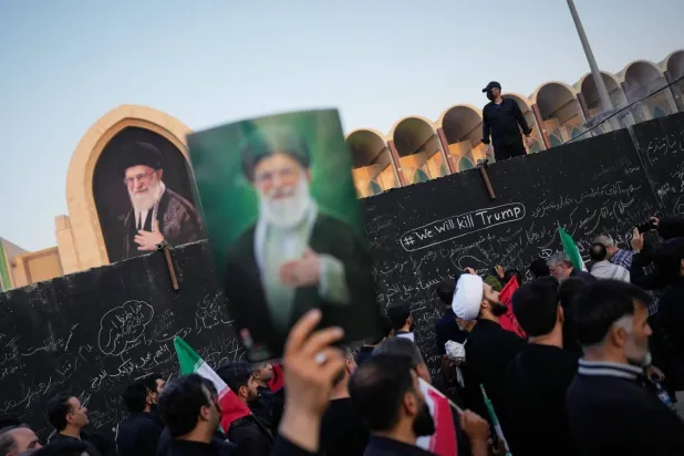 A mourner holds a poster of Ali Khamenei during his funeral procession in Tehran. (AP)