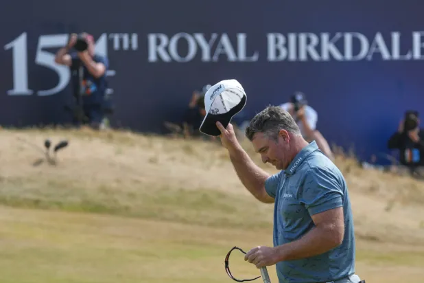 Ryan Fox of New Zealand acknowledges the crowd on the 188th green after completing his third round during the third day of the British Open Golf championships at Royal Birkdale golf club, in Southport, England, Saturday, July 18, 2026. (AP Photo/Jon Super)