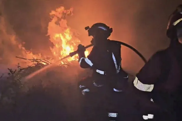 This screen grab taken from handout video footage released on July 18, 2026 by Spain's Military Emergencies Unit (UME) shows the military fighting a massive wildfire, in Luesia area, in a sparsely populated part of the Aragon region in northeastern Spain. (Photo by Handout / UME / AFP)