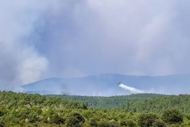 A seaplane battles a wildfire that started on Thursday in La Mierla, Guadalajara, July 18, 2026. (EPA)