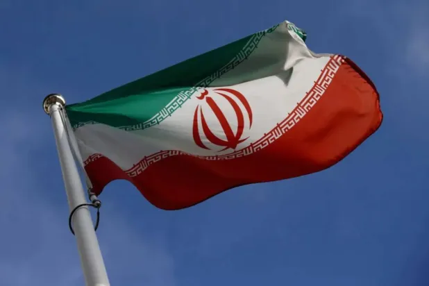 The Iranian flag waves in front of the International Atomic Energy Agency (IAEA) headquarters, before the beginning of a board of governors meeting, in Vienna, Austria, March 1, 2021. REUTERS/Lisi Niesner 