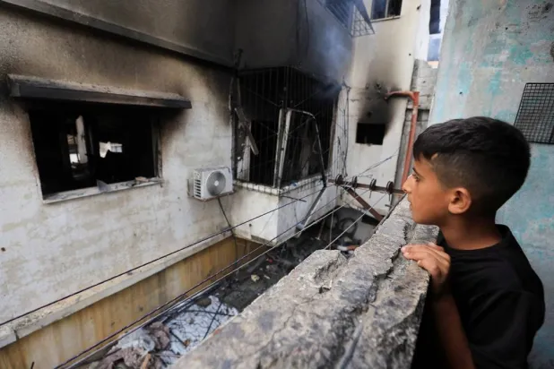 A Palestinian boy inspects the site of an Israeli strike on a house in Gaza City, July 21, 2026. (Reuters)