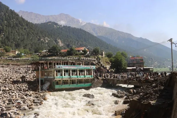 Floodwaters near a hotel and guest house building in Parun, the capital of Nuristan province, Afghanistan, July 21, 2026. (Reuters) 