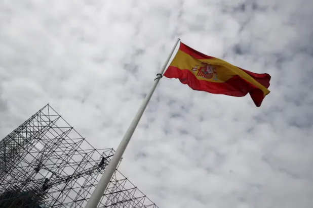 Workers set up a huge scaffold as a Spanish flag flutters at the Colon square in Madrid, Spain, November 2, 2021. REUTERS/Sergio Perez