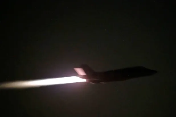 A US military aircraft flies at an unknown location, during what US Central Command (CENTCOM) says are strikes on Iran, in this screengrab taken from a handout video released on July 20, 2026. (US Central Command/Handout via Reuters)