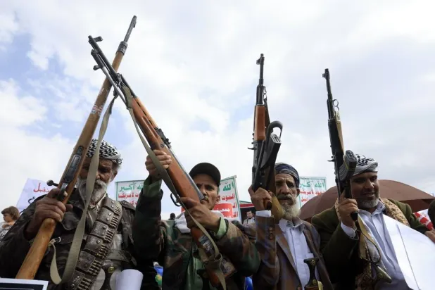Houthi supporters hold up their weapons during a protest in Sanaa, Yemen, 17 July 2026. (EPA)