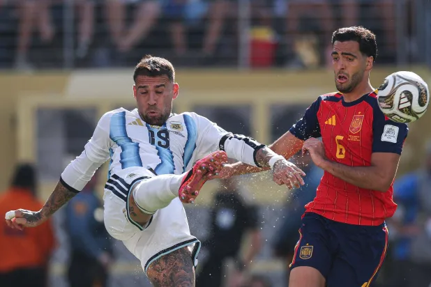 TOPSHOT - Argentina's defender #19 Nicolas Otamendi kicks the ball past Spain's midfielder #06 Mikel Merino during the 2026 World Cup football tournament final match between Spain and Argentina at the New York/New Jersey Stadium in East Rutherford on July 19, 2026.  (Photo by PATRICIA DE MELO MOREIRA / AFP)