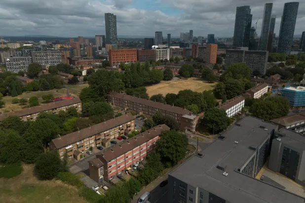 An aerial photograph taken with a drone shows high-rise towers behind social housing blocks in Manchester, Britain, 23 July 2026.  EPA/ADAM VAUGHAN