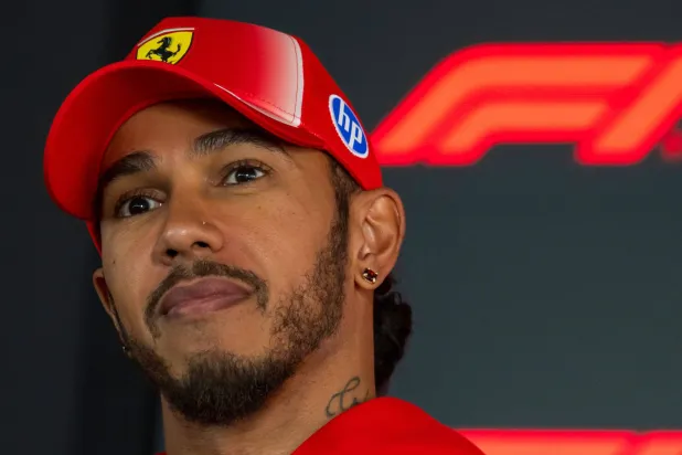 Ferrari's British driver Lewis Hamilton talks to the media in the paddock ahead of the Formula One Hungarian Grand Prix at the Hungaroring circuit in Mogyorod near Budapest, Hungary, on July 23, 2026. (AFP) 