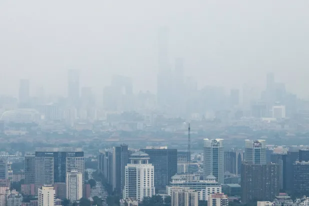 Skyscrapers in Beijing's Central Business District (CBD) and the Forbidden City are seen through haze in Beijing, China, July 24, 2026. REUTERS/Maxim Shemetov