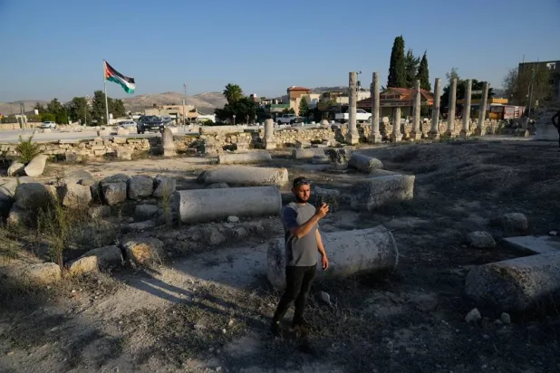 A Palestinian visitor takes a photo at the Roman historical site in the West Bank town of Sebastia, Thursday, Nov. 20, 2025. (AP)