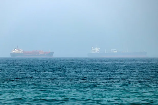 Cargo vessels are seen at one end of the Strait of Hormuz near the coast of Dibba Al Fujairah, United Arab Emirates, 21 July 2026.  EPA/STRINGER