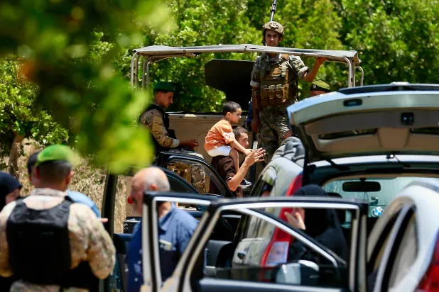 Residents of Zawtar gather near a Lebanese army checkpoint as they are allowed to return to their town following a four-day wait, in Zawtar al-Gharbiyeh, southern Lebanon, 24 July 2026. (EPA)