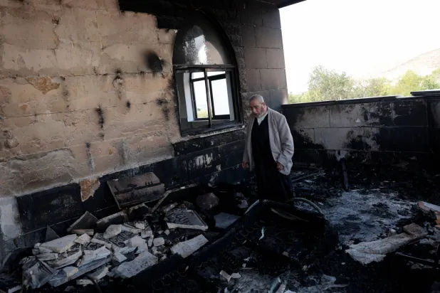 A Palestinian man inspects the damage at a mosque, which Palestinians say was damaged by Israeli settlers, in Qusra near Nablus, in the Israeli-occupied West Bank, July 26, 2026. REUTERS/Mohamad Torokman