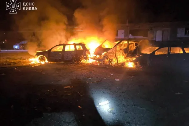Smoke and fire rise from burning vehicles at a site of a Russian strike, amid Russia's attack on Ukraine, in a location given as Kyiv, Ukraine, in this handout picture released on July 26, 2026. State Emergency Service of Ukraine in Kyiv Region/Handout via REUTERS 