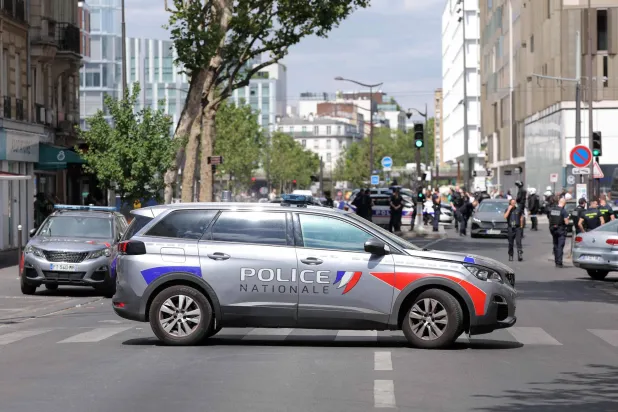French police block a street after a knife-wielding man wounded three people in Paris on July 27, 2026.  (Photo by Kenzo TRIBOUILLARD / AFP)