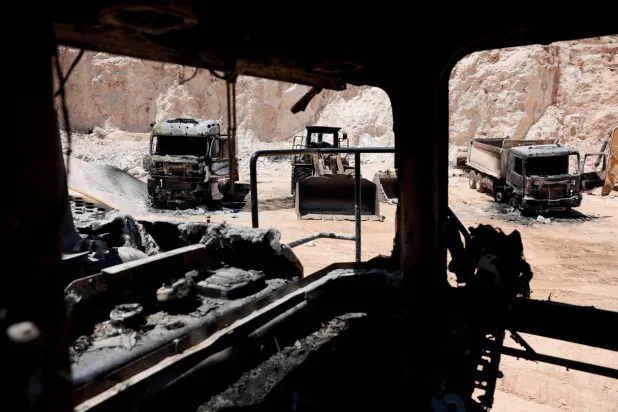Heavy machinery that was burned inside a Palestinian quarry after Palestianians say Israeli settlers attacked yesterday, near Ramallah, in the Israeli-occupied West Bank, July 27, 2026.  REUTERS