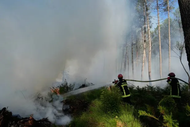 Firefighters work to suppress flames near Lacanau, as wildfires rage outside Bordeaux, France, Monday, July 27, 2026. (AP)
