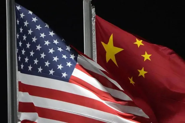 File photo: The American and Chinese flags wave at Genting Snow Park ahead of the 2022 Winter Olympics, in Zhangjiakou, China, on Feb. 2, 2022. (AP)

