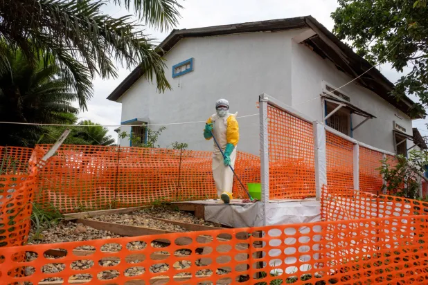 A Congolese health worker cleans outside her station during the tour by Democratic Republic of Congo Prime Minister Judith Suminwa Tuluka, at the Mongbwalu General Hospital in the Ebola-stricken town of Mongbwalu, July 24, 2026. (Reuters)