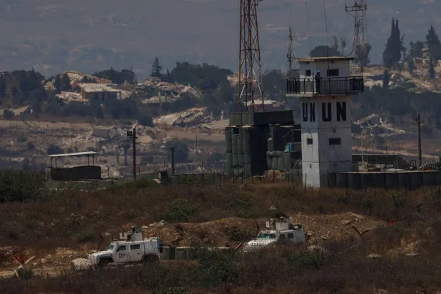 This picture, taken from a position in northern Israel, near the border with Lebanon, shows United Nations Interim Force in Lebanon (UNIFIL) armored vehicles driving past destroyed buildings in southern Lebanon on July 22, 2026. (AFP)