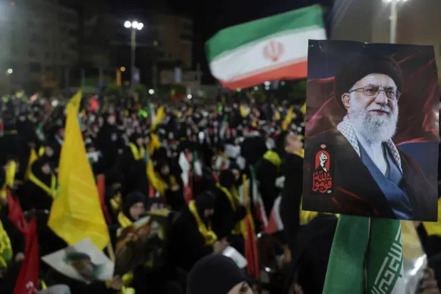 Hezbollah supporters wave the group’s flag and the Iranian flag in Beirut’s southern suburbs during the funeral of former Iranian Supreme Leader Ali Khamenei (EPA)